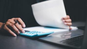 income tax management concepts and investment finance, management of accounting documents and budgets, annual statement review and analysis.paying the tax rate.businessman working on his desk photo