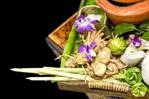 Top view of many Thai herbs for treatment or massage in Thai spa isolate on black background. photo