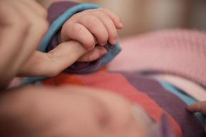 mother is playing with baby at home photo