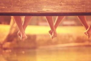 people sitting at wooden bridge photo