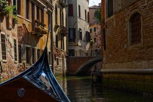 Gondola sailing in the canals of Venice photo