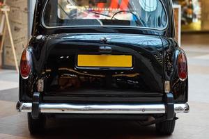 Closeup of a black vintage car.  Back view part of retro car photo