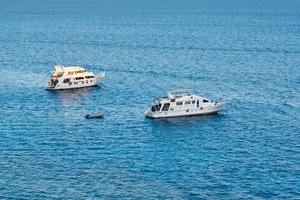 Two white ship in blue water of sea or ocean photo