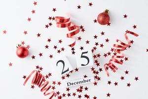 Red glitter confetti and decorations on a white background photo