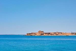 Beautiful view of sea cost against blue sky photo