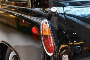 Closeup of a black vintage car.  Back view part of retro car photo