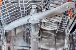 a dishwasher machine carriage close up. Domestic kitchen appliance parts photo