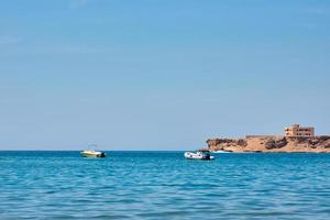 Beautiful view of sea cost against blue sky photo