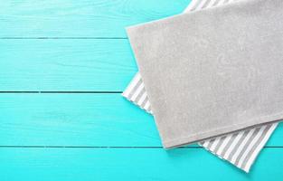 Gray and white striped tablecloth on blue wooden kitchen. Top view and copy space. Mock up photo