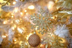 Christmas decorations on a fir tree close-up. Toys, cones, garlands with lights, balls, beads. New year, festive background. photo