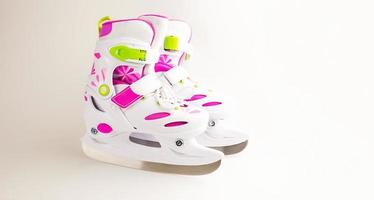 Children's ice skates with size adjustment-sliding with fixation. Plastic skates on a white background, copyspace photo