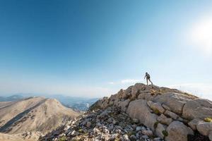 The girl travels in the mountains. photo