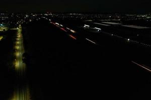 Night Aerial View of British Motorways with illuminated Roads and Traffic. Highways footage taken with drone's camera over Milton Keynes and motorways of England at Dark Night photo