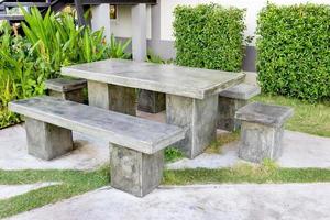 stone table set in garden photo