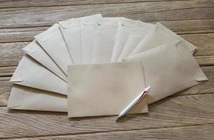 Brown Letter Envelop with pen on wooden table,filter effect photo