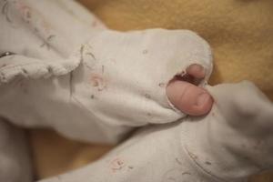 One month newborn baby sleeping  in bed photo