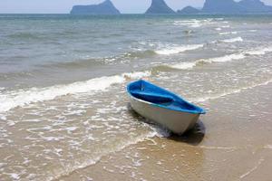 blue boat on the beach photo