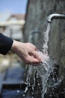 fresh mountain water falling on hands photo