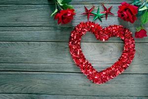 Tinsel heart  decoration on wood background,filter effect. photo