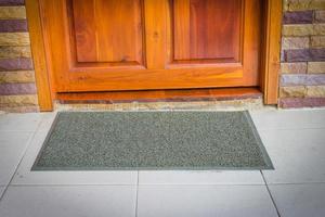 gray door mat  with close door photo