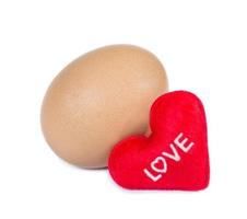 red heart-shaped with egg on background photo