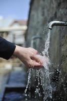 fresh mountain water falling on hands photo