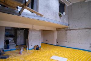 yellow underfloor heating installation with white pipes photo