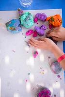 kid hands Playing with Colorful Clay photo