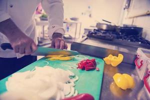 Chef hands cutting fresh and delicious vegetables photo