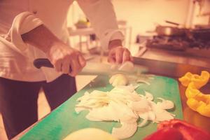 Chef hands cutting fresh and delicious vegetables photo