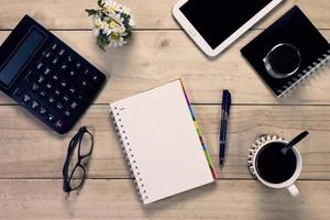 note book with  pen and office equipment on desktop photo