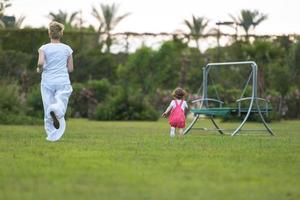 mother and little daughter playing at backyard photo