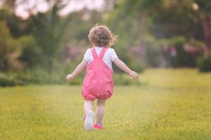 little girl spending time at backyard photo