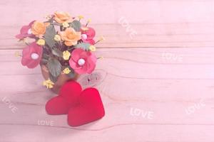 two heart-shaped with flower on wood photo