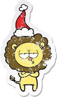 distressed sticker cartoon of a tired lion wearing santa hat vector