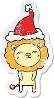 distressed sticker cartoon of a lion wearing santa hat vector