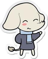 sticker of a cute cartoon elephant in winter clothes vector