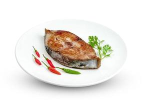 King mackerel or spotted mackerels steak with dish isolated on white background ,fried Scomberomorus fish ,include clipping path photo