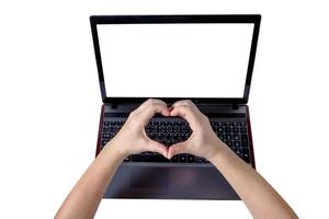 Woman hands making a heart shape on laptop isolated on white background,clipping path photo
