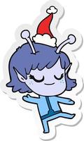 smiling alien girl sticker cartoon of a wearing santa hat vector