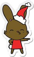 Curiosa pegatina de conejito caricatura de un sombrero de Papá Noel que lleva puesto vector