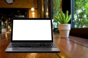 Laptops on desk with blur restaurant background,top wooden table photo