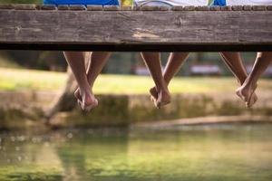 people sitting at wooden bridge photo