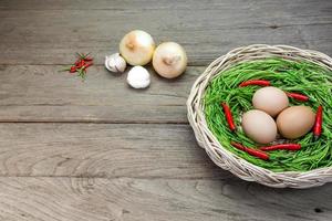 Acacia pennata and egg in basket on wood background photo