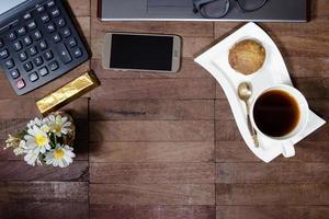 coffee with banana cup cake and office equipment on desktop photo