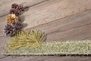 pine cones and gold leaf on the wooden board,christmas background photo