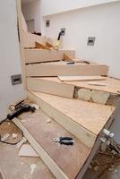 work in progress on stylish interior with wooden stairs photo