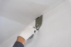 construction worker plastering on gypsum walls photo