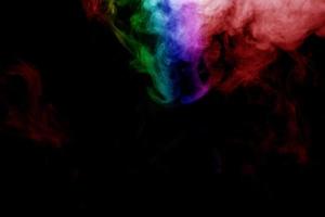 humo abstracto aislado sobre fondo negro, polvo de arco iris foto