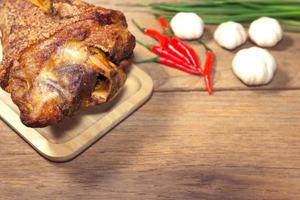 fried pork leg cooked on chopping block photo